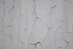 Close-up of a thin crack on a painted interior wall