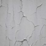 Close-up of a thin crack on a painted interior wall