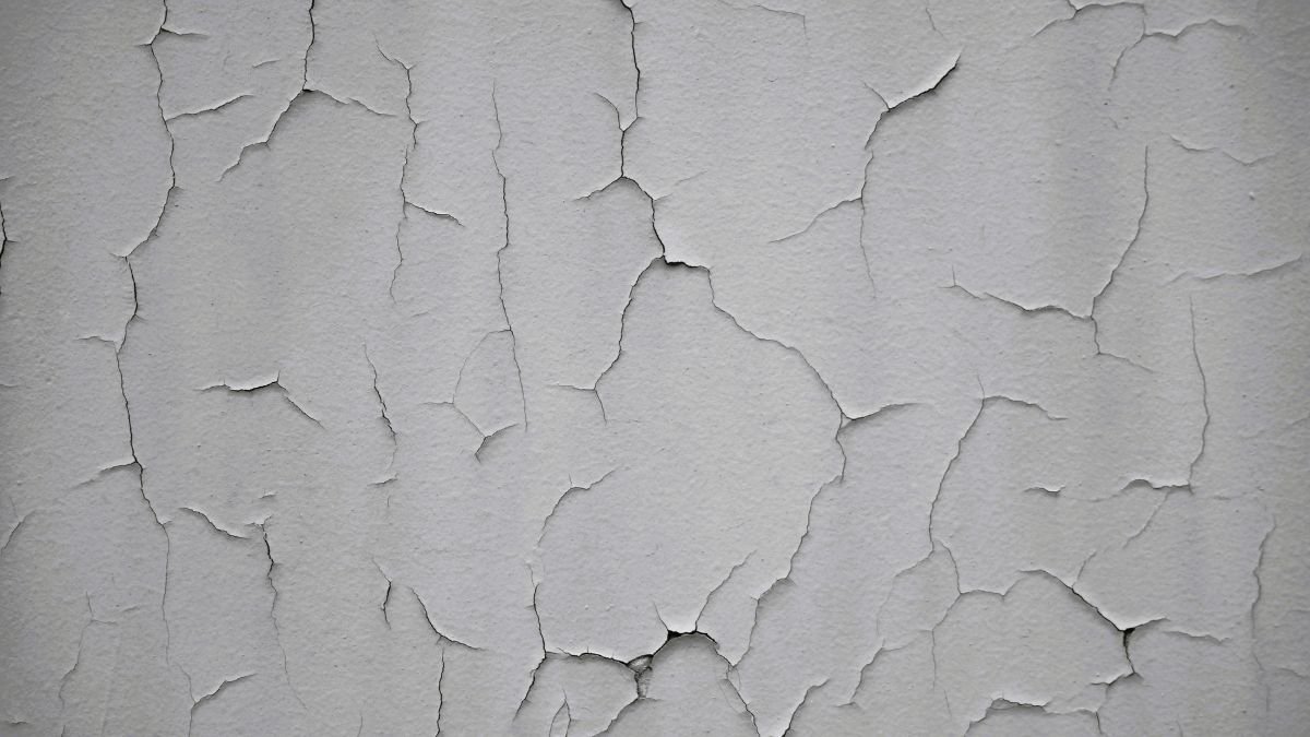 Close-up of a thin crack on a painted interior wall